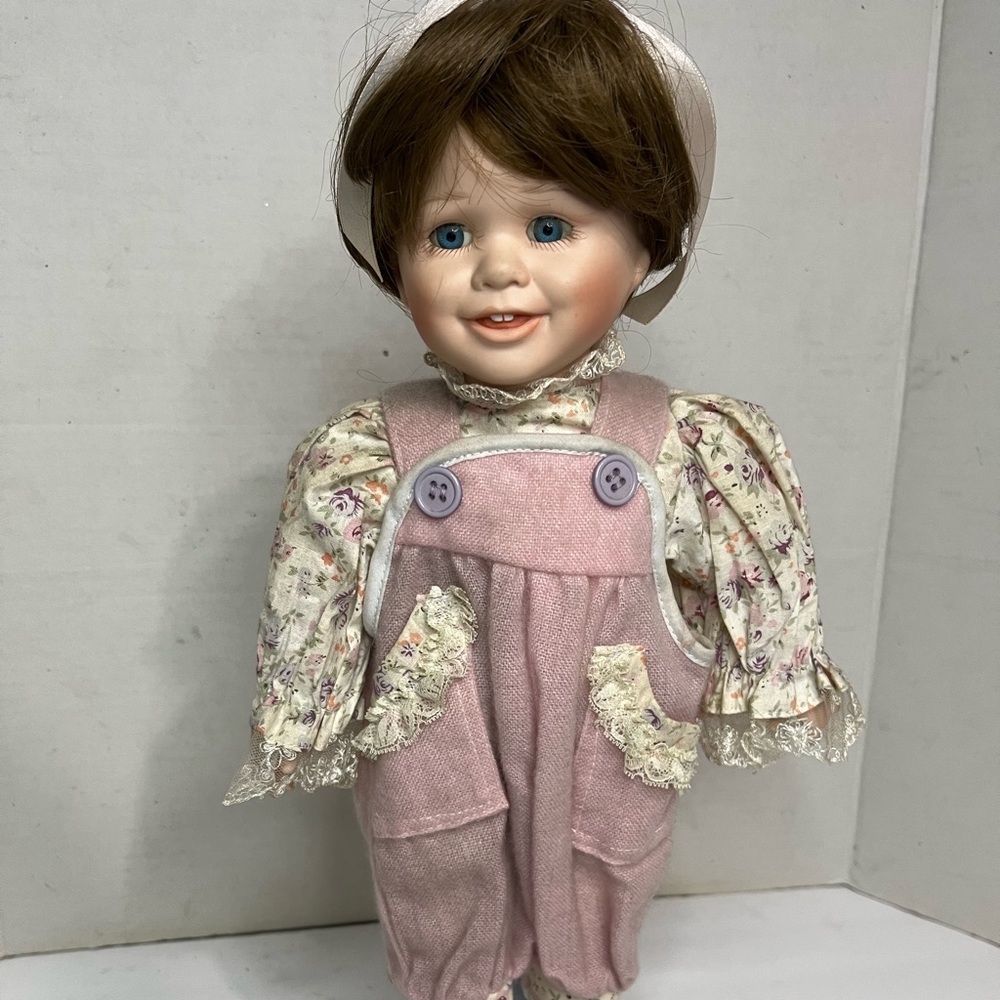 Design Debut porcelain Doll 1390/2006 Brown Short Hair, Blue Eyes, Pink Jumpsuit